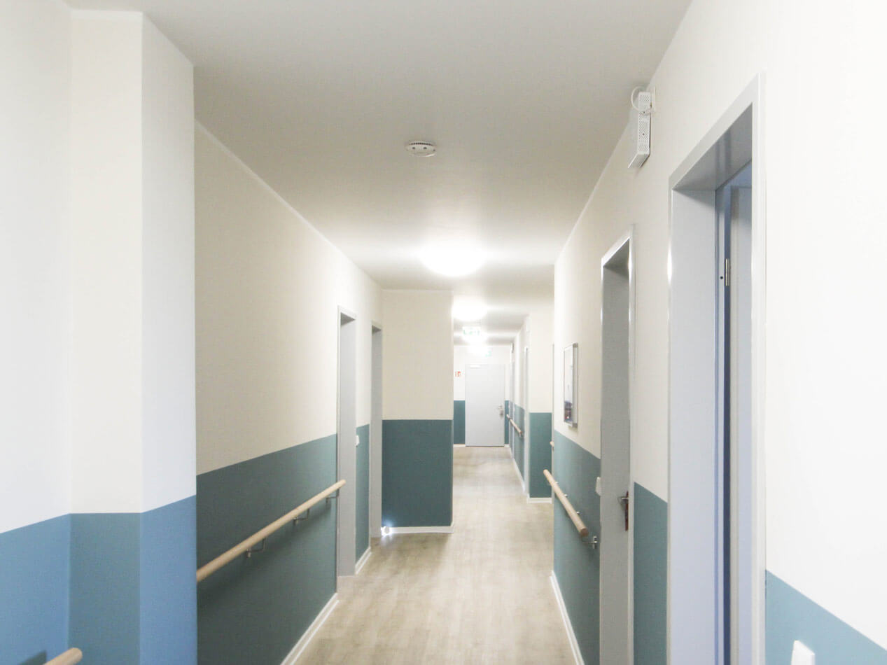 BAHN5-19-1267 Innenansicht des barrierefreien Flurs nach dem Umbau in blau-weißer Wandgestaltung.