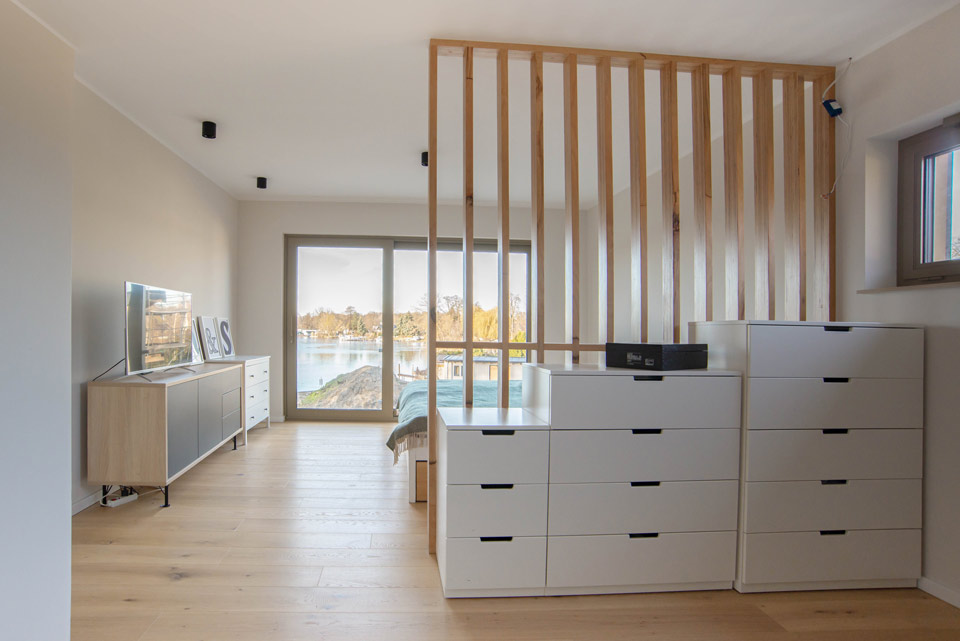 Blick in das hell möblierte Schlafzimmermit und Ausblick auf den See.